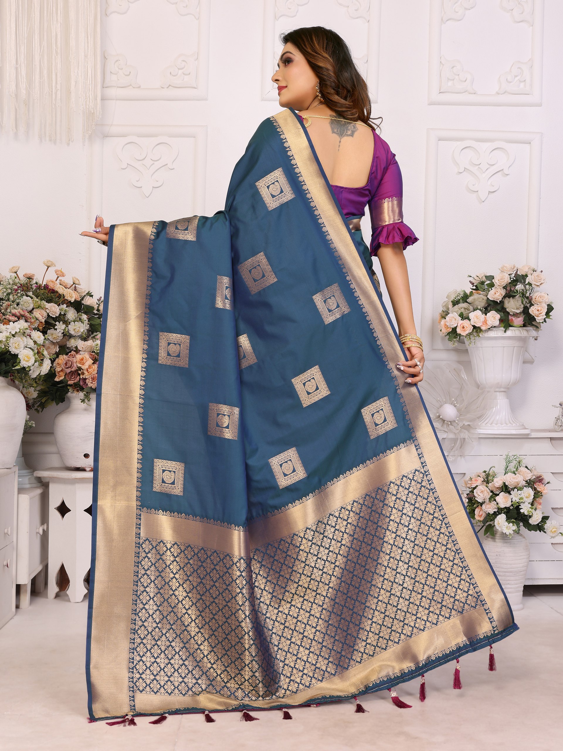 Soft Silk Saree featuring an elegant woven Butta motif embellishing the body