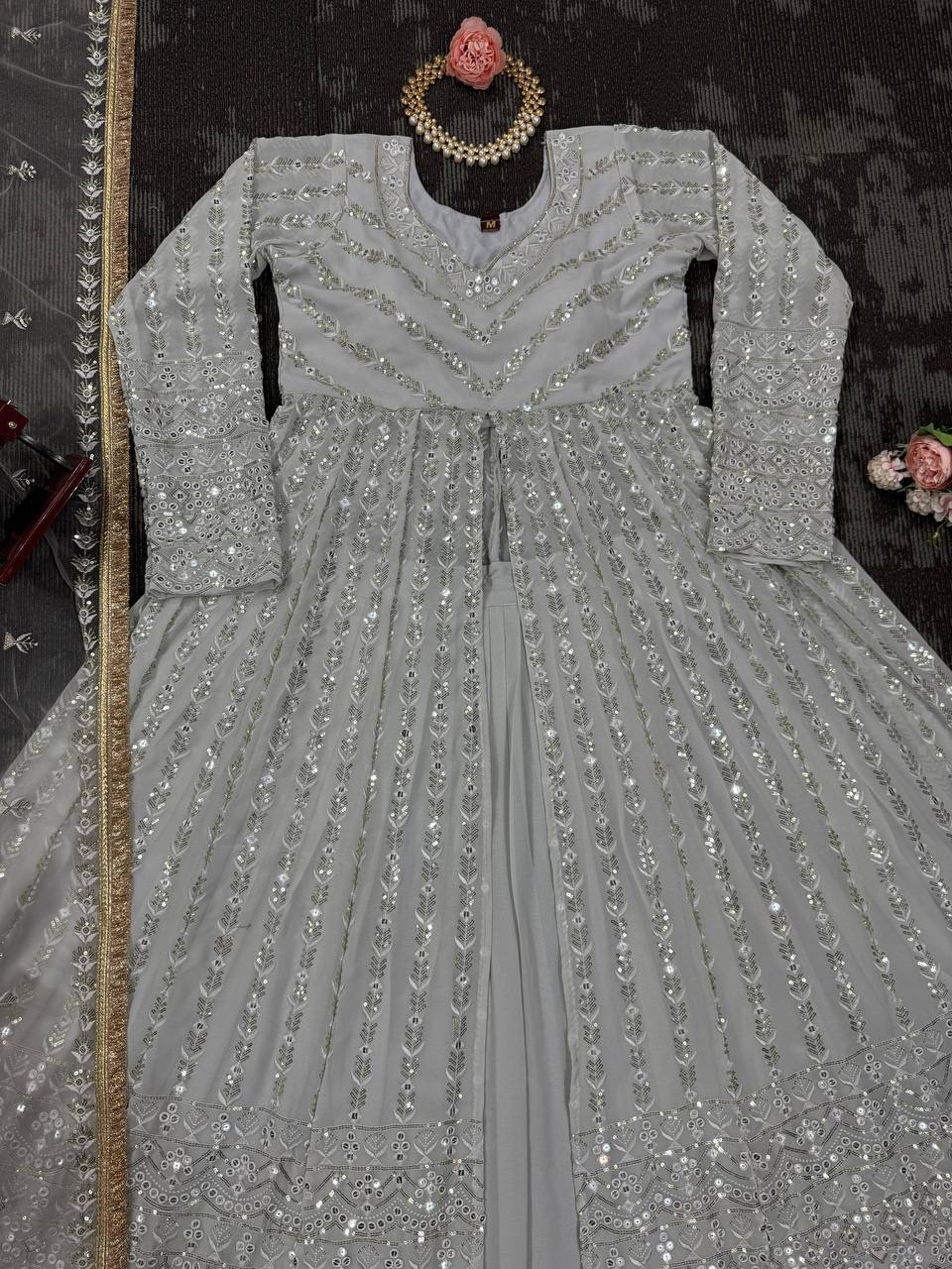 Elegant three-piece ensemble featuring a faux georgette top and lehenga with dupatta