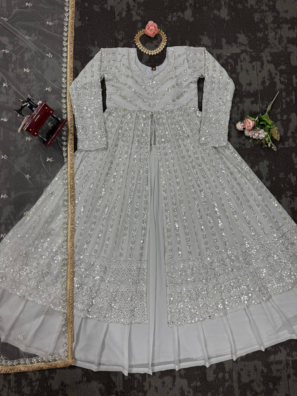 Elegant three-piece ensemble featuring a faux georgette top and lehenga with dupatta